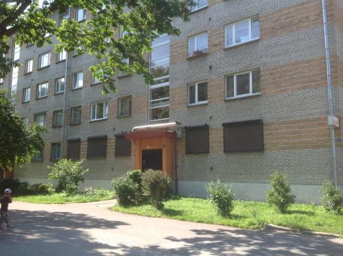 纳尔瓦Yulia Apartment的前面有一辆自行车的人在砖砌的建筑