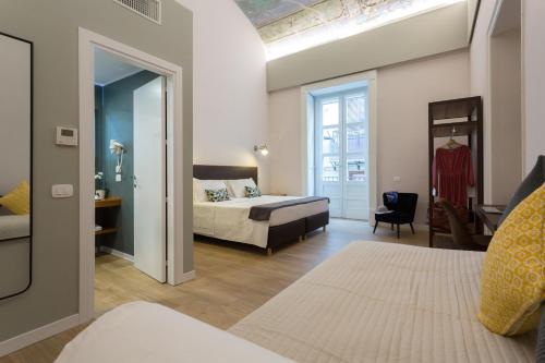 Bellaroto Suite & SPA客房内的一张或多张床位