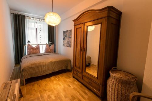 莱比锡Apartment Waldstraßenviertel的一间卧室配有一张床、梳妆台和镜子