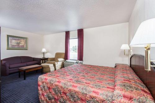 弗吉尼亚海滩弗吉尼亚海滩林恩海文骑士汽车旅馆的酒店客房,配有床和沙发