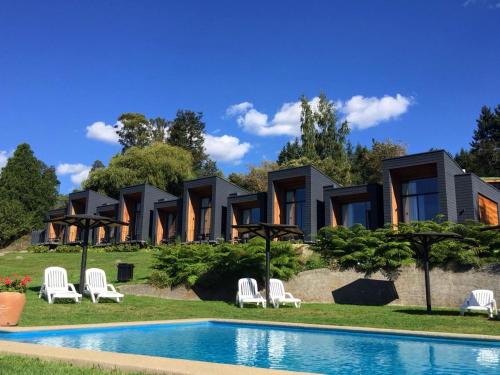 比亚里卡Hotel y Cabañas El Parque的一座房子前面设有游泳池