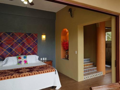 锡瓦塔塔内霍Casa Arcoiris Zihuatanejo B&B的卧室配有一张床,墙上设有冲浪板