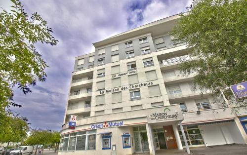 旺德夫尔莱南锡KOSY Appart'Hôtels - La Maison Des Chercheurs的一条城市街道上的白色大建筑