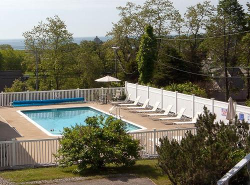 格洛斯特海狮汽车旅馆 的一个带椅子和白色围栏的游泳池
