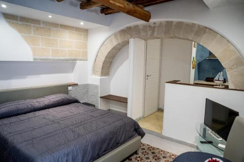 特拉帕尼Cortile Azzurro的一间卧室配有一张床和电视