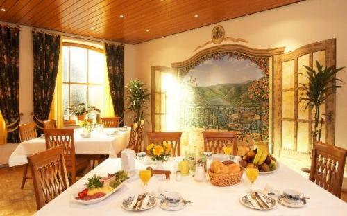 施派Hotel Alter Posthof的用餐室配有餐桌和食物