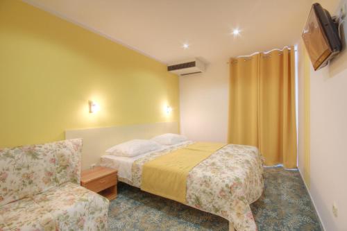 萨利萨利酒店的配有一张床和一把椅子的酒店客房