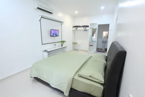 Pengkalan Cepa哥打巴鲁机场中转索菲宾馆的一间白色客房内配有一张大床的卧室