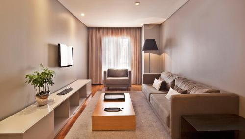 里斯本阿尔迪斯普利姆酒店的客厅配有沙发和桌子