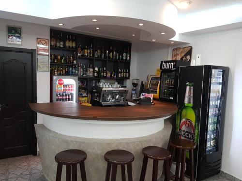 锡纳亚Cristal Sinaia的酒吧配有凳子和一瓶啤酒