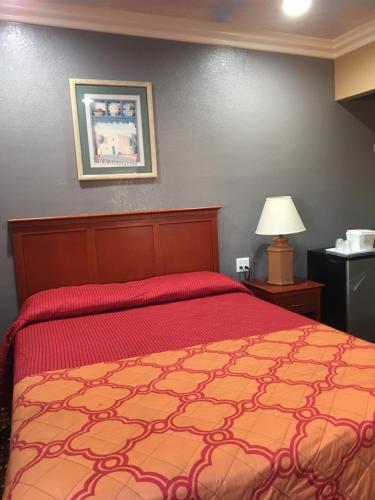 朗代尔Budget Inn LAX-Lawndale的一间卧室配有一张红色床罩的床