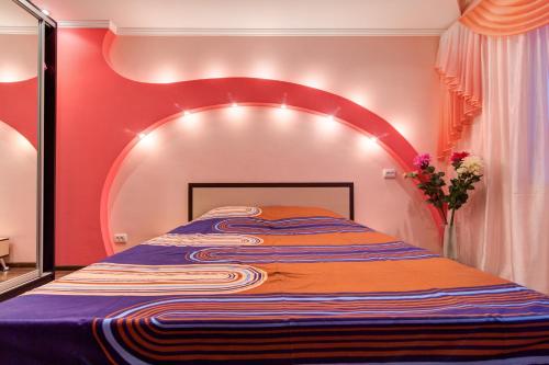 第聂伯罗Apartment on Riverfront of Dnepr的一张大床,位于一个红色墙壁的房间
