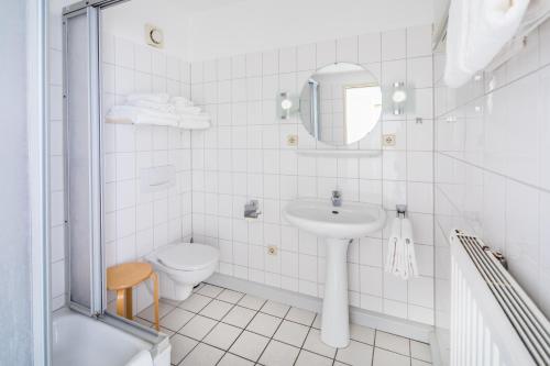 诺德奈Birkenhof的白色的浴室设有水槽和卫生间。