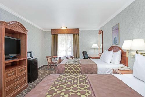 朗代尔南/曼哈顿海滩戴斯酒店的酒店客房设有两张床和一台平面电视。