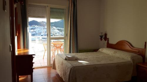圣何塞欧莱斯酒店的一间卧室设有一张床和一个大窗户