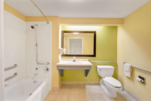 迪索托德索托戴斯旅馆及套房酒店的浴室配有白色卫生间和盥洗盆。