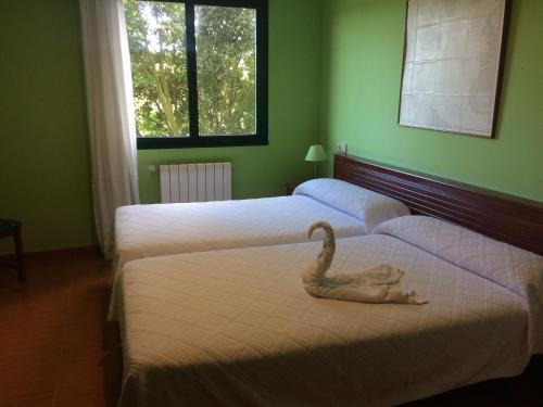 班奴古斯布里萨玛酒店的一间设有两张床的房间,上面有天鹅