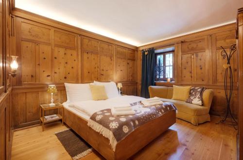 崔聂斯Chaletapartement Ambiente Villa Mozart的一间卧室配有一张大床和一张沙发