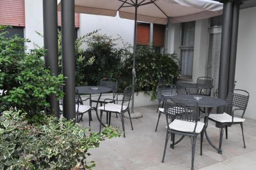 特雷维索艾克佛尔酒店的一个带桌椅的伞下庭院