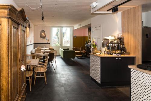 Den HamHerberg Swaen aan de Brink的厨房以及带桌椅的用餐室。