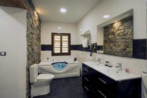 EaUrdaibai Etxea的浴室配有卫生间、盥洗盆和浴缸。
