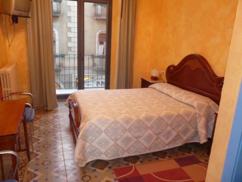 拉维斯瓦尔阿达纽斯旅馆的一间卧室设有一张床和一个大窗户