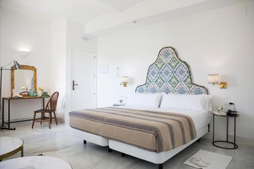 塞维利亚Santiago 15 Casa Palacio的一间卧室配有一张大床和大床头板