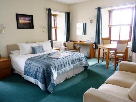 瑟索Pentland Lodge House的卧室配有一张床和一张桌子及椅子