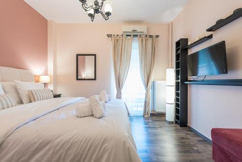 雅典Athens Mini Suite的一间卧室配有两张床和一台平面电视