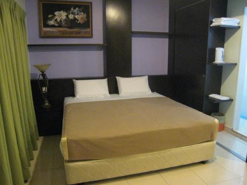 实兆远特罗皮卡那经济型酒店的一间卧室,卧室内配有一张大床