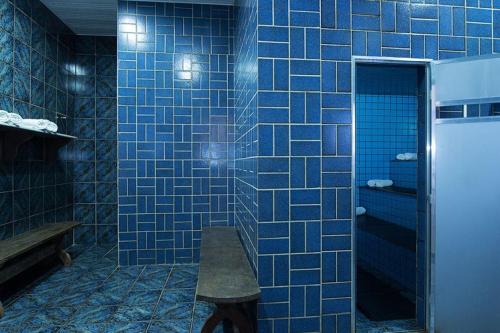 瓜拉派瑞Hotel da Lea的蓝色瓷砖浴室设有长凳
