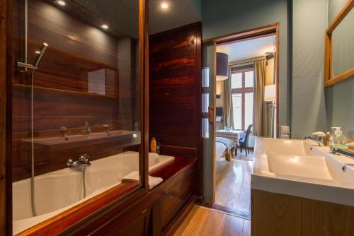 布鲁日Cornerhouse Level Ten by Romy&Travis的带浴缸、水槽和镜子的浴室