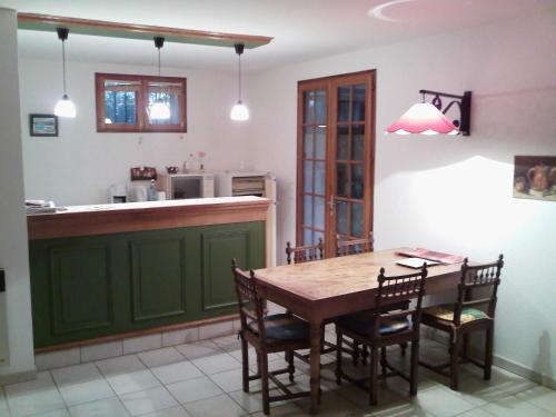 吕奥姆gîte en sud Ardèche的厨房配有木桌和椅子