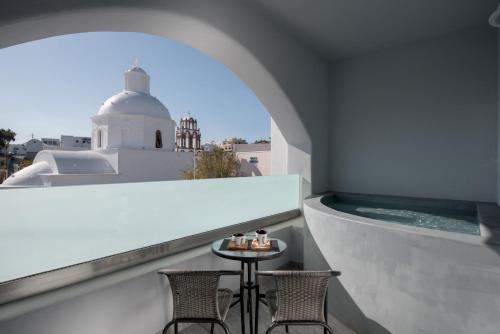 卡特瑞杜斯Ikies Santo Filoxenia Apartments的阳台享有美景,配有2把椅子和1张桌子