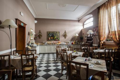罗马法尔内塞利兹但萨酒店的一间带桌椅的餐厅和一间厨房