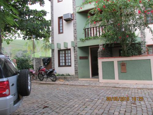 CambuciPousada Beija Flor的停在大楼前的两辆摩托车