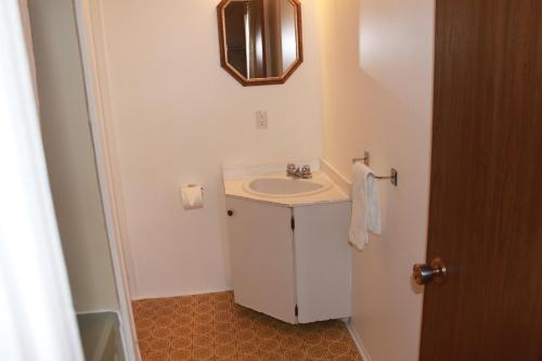 布兰维尔博伊西汽车旅馆的白色的浴室设有水槽和镜子