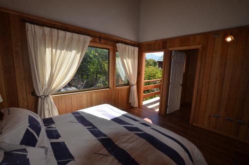 拉斯特朗卡斯Cabañas Las Cabras的一间卧室设有一张床和一个大窗户