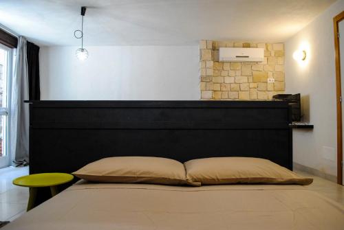 滨海波利尼亚诺Underground 22的一张床上,上面有黑色床头板