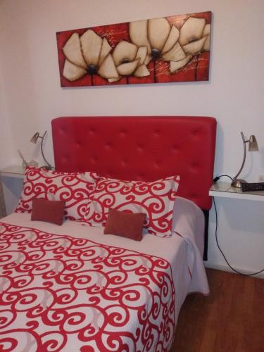 科尔多瓦贝库斯公寓的卧室里红色的床和红色床头板