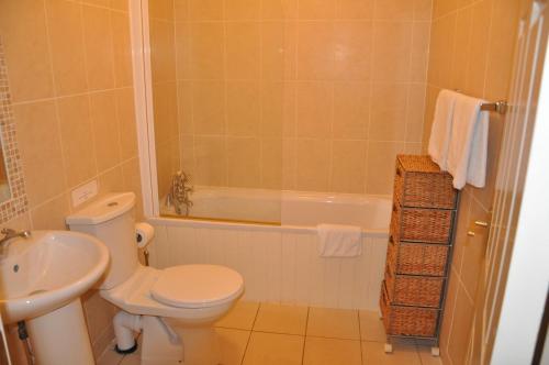 索兹Heyward Mews Holiday Homes的浴室配有卫生间、浴缸和水槽。