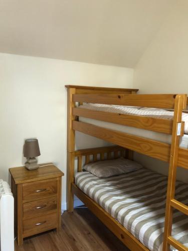 德拉姆纳德罗希特1 Lochness Rooms&Hostel的一间卧室设有两张双层床和床头柜。
