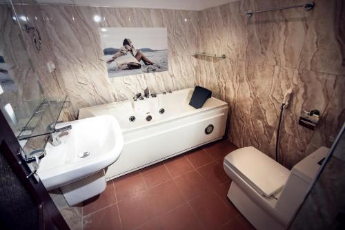 康提Heavens Door Guest Inn的一间带水槽、浴缸和卫生间的浴室