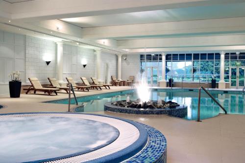 奇切斯特古德伍德酒店 的一个带热水浴缸和壁炉的游泳池