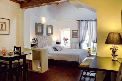 圣地亚哥－德孔波斯特拉Inicia Casas Reales的一间卧室配有一张床、一张桌子和一张书桌