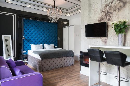 基辅塞尔特精品公寓酒店的一间卧室配有一张床、一台电视和紫色家具