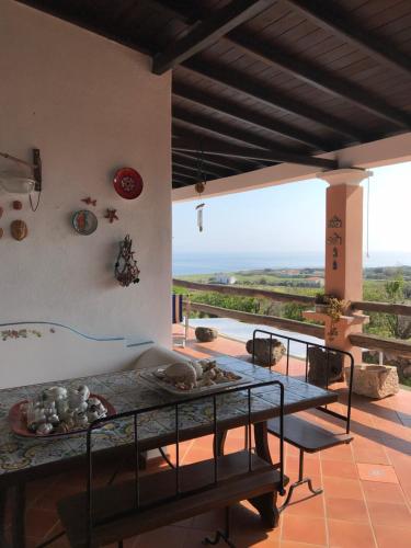 乌斯蒂卡Case del Tramonto的客房设有一张桌子和一个美景阳台。