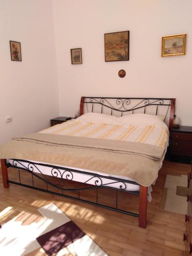 布拉索夫Mama Brasov的卧室内的一张床位,铺有木地板