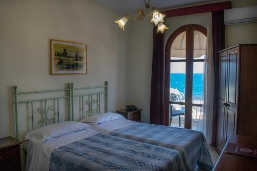 贾迪尼-纳克索斯Hotel Porto Azzurro的一间卧室配有一张床,享有海景