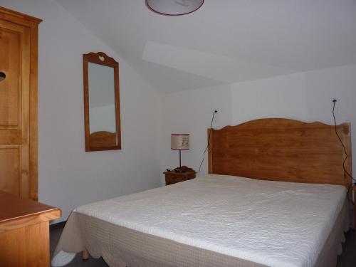瓦尔Résidence Odalys Pra Sainte Marie的卧室配有一张床,墙上设有镜子